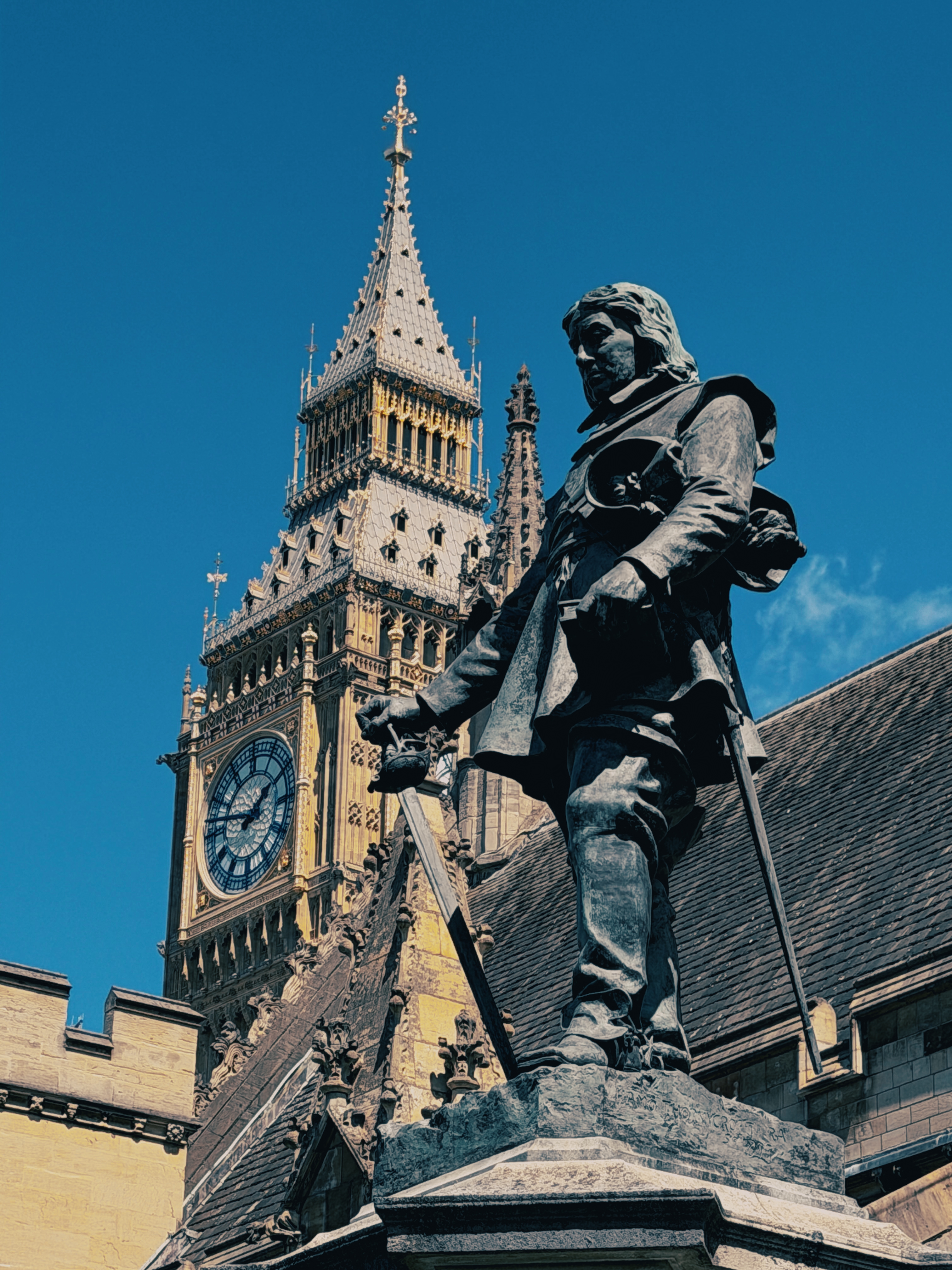Photo of a statue and "Big Ben" in the background.